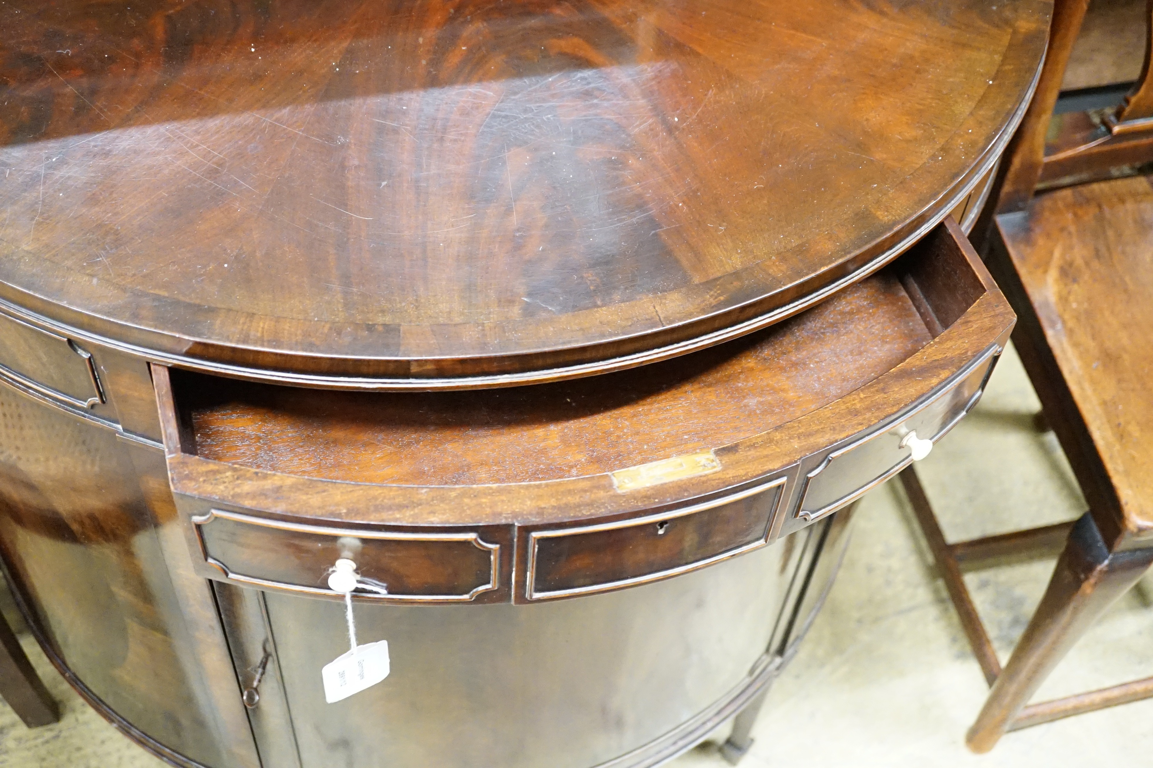 An early 20th century Maple & Co. mahogany demi-lune side cabinet with frieze drawer, width 84cm, height 84cm